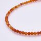 Carnelian and Sterling Silver Bracelet, image shows close-up of part of gemstone strand on plain white background
