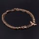 Rose Gold Bee and Gemstone Bracelet, image shows bracelet on black glossy surface