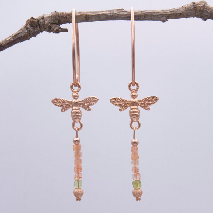 Rose Gold Bee and Gemstone Earrings, shown suspended from twig with white background