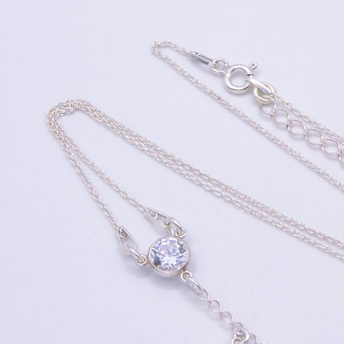 Sterling Silver and Cubic Zirconia Lariat Necklace, image shows close-up of cubic zirconia focal point and part of chain, on plain white background
