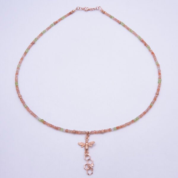 Rose Gold Gemstone and Bees Necklace, shown from above on plain white background